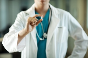 a doctor holding a medication capsule