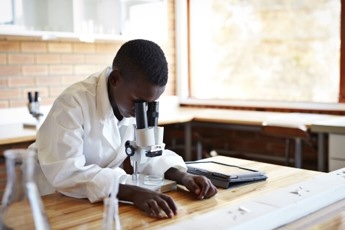 medical scientist using a microscope